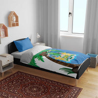 Sierra Leone bedding set on bed: blue duvet with coat-of-arms graphic and palm leaves, two pillows