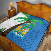 Sierra Leone quilt blanket on bed with blue crest center and white palm motif