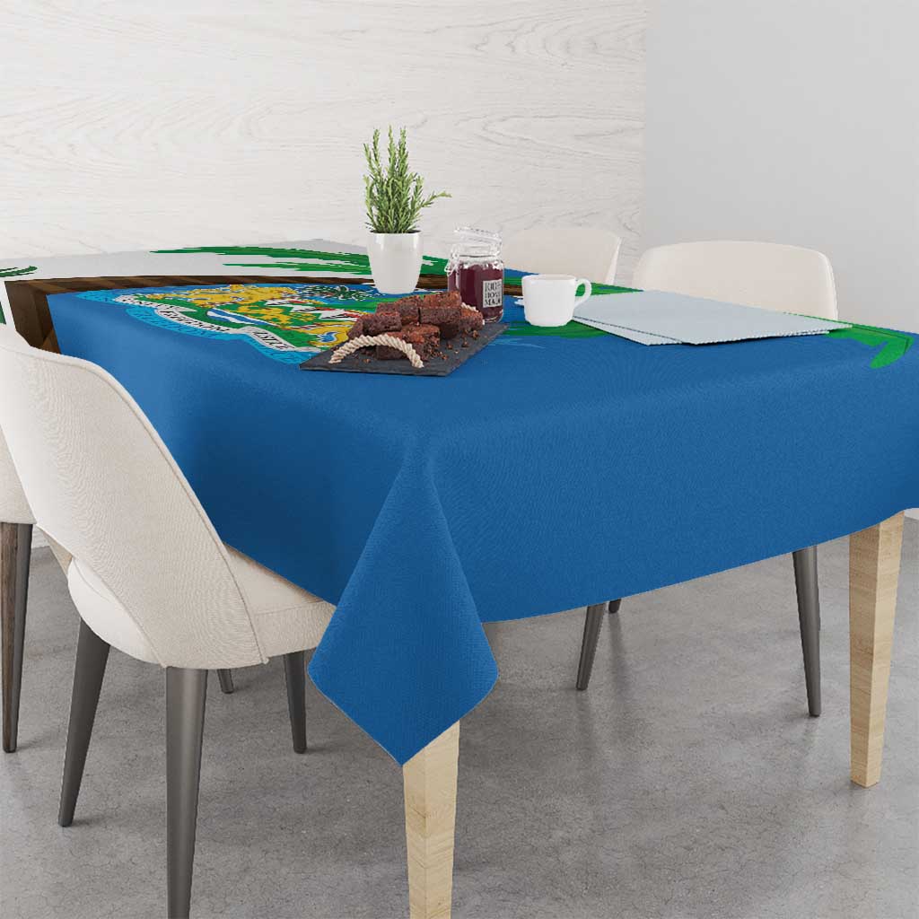 Blue tablecloth draped on table, Sierra Leone coat of arms and flag map graphic