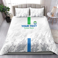 White bedding set with two pillowcases, grey silhouette pattern and blue/green central stripe