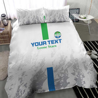 White bedding set with two pillowcases, grey sports silhouettes and blue/green center stripe