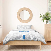 White duvet cover with grey sports pattern and blue/green stripe, styled with two pillowcases
