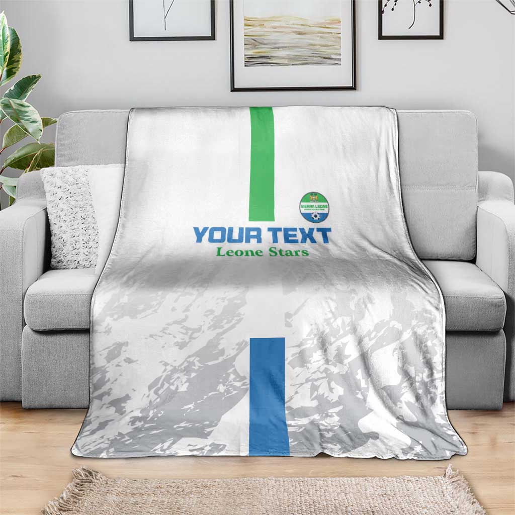Gray football blanket with green and blue vertical stripe and Leone Stars emblem