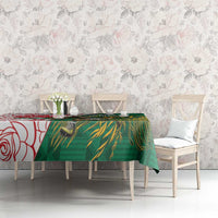 Green rugby tablecloth with bird-and-leaf print and red rose motif, on table