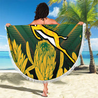 Round green beach blanket with white fringe, kangaroo graphic and custom text, held outdoors