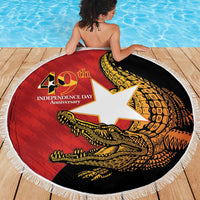 Round beach blanket on deck, fringed edge, red/black 40th Independence Day crocodile graphic