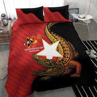 Red and black duvet cover set with crocodile emblem and two pillow shams on bed