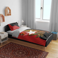 Red and black duvet cover and pillow shams featuring crocodile emblem on bed