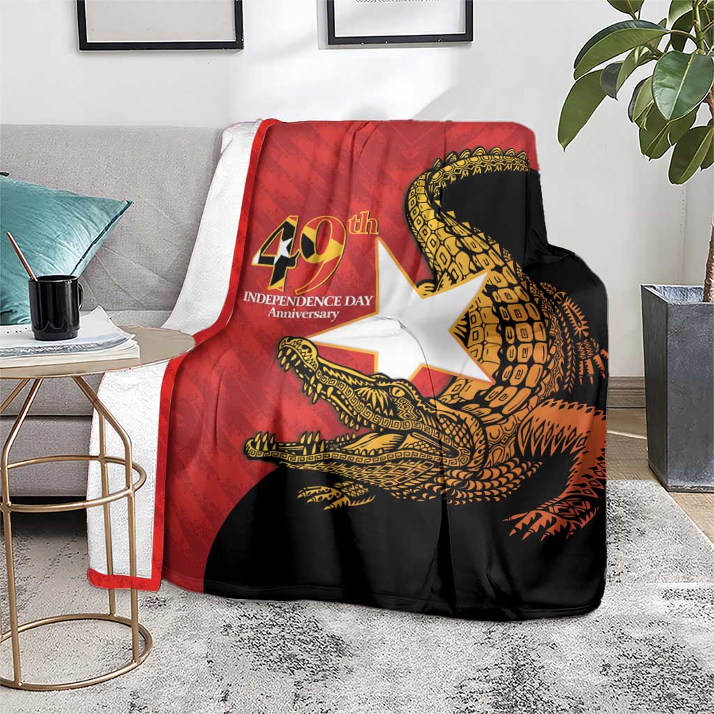 East Timor Independence Day blanket on seating, red and black with gold crocodile design