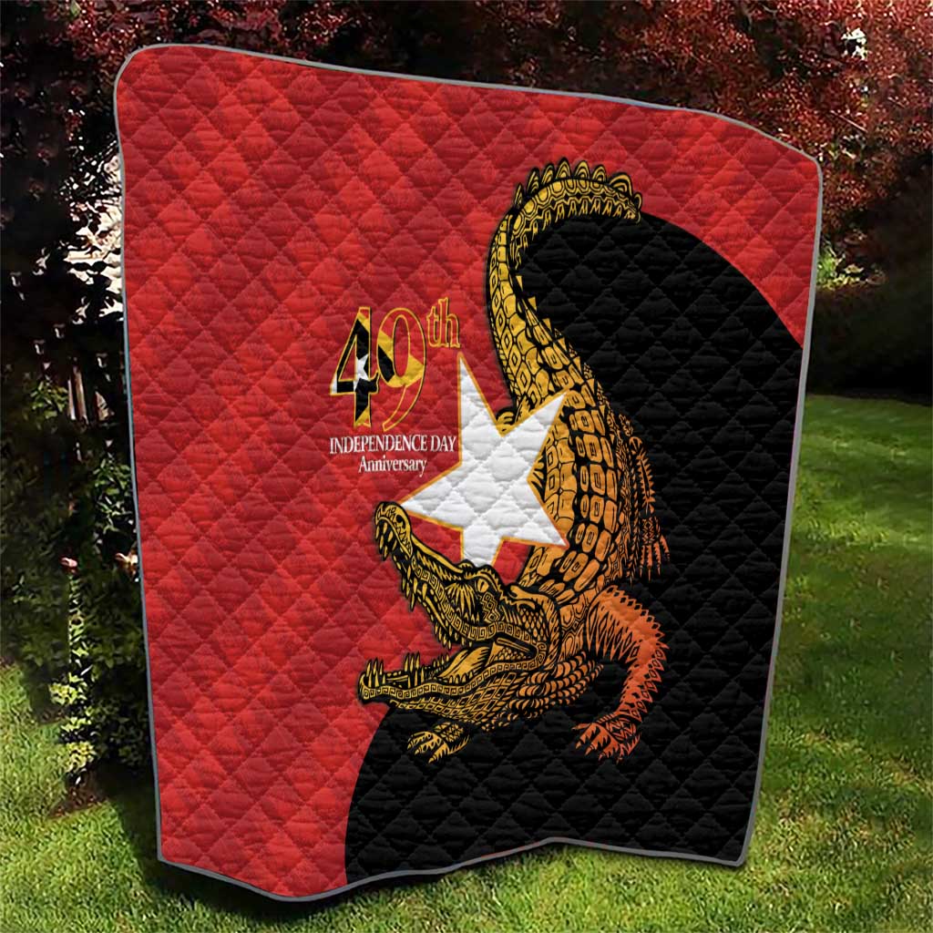 Red and black quilt blanket with quilted texture and golden crocodile emblem, 40th Independence Day