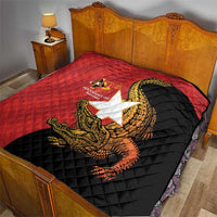 Red and black bed quilt with quilted diamonds and golden crocodile graphic over the star panel