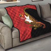 Red and black throw quilt on sofa with quilted pattern and golden crocodile graphic, 40th anniversary