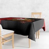 Black tablecloth with red edge and gold crocodile-themed strip, folded corner on bench