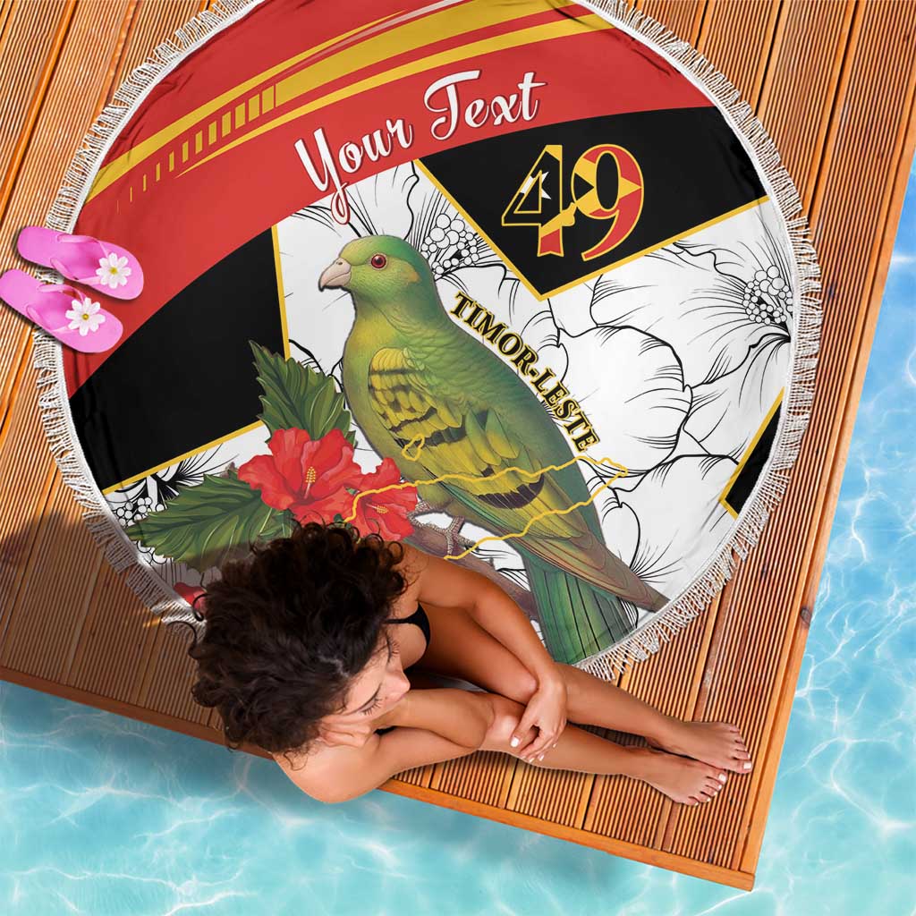 Round beach blanket with red, black, and white bird and hibiscus print, fringed border