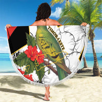 Round beach blanket with bird and hibiscus graphic, fringed edge, held on sand