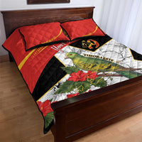 Red quilt bed set with two pillows, bird, hibiscus flowers, and black-and-white emblem panel