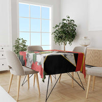 Tablecloth draped on rectangular table; red, black, and white bird and hibiscus print