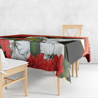 Red, black, and white tablecloth with hibiscus and bird design across edges