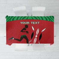 Red tablecloth with green border and sports-themed runner and animal silhouette print
