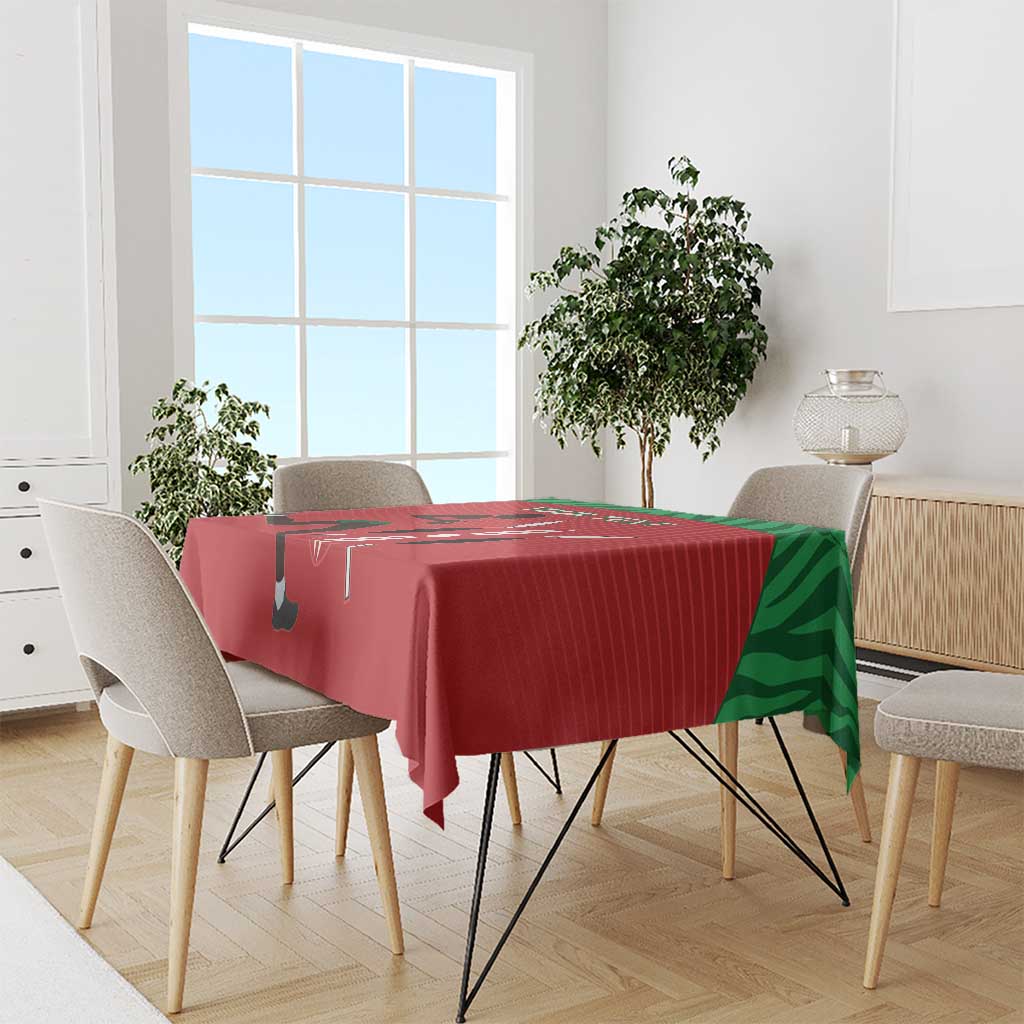 Red tablecloth runner on a dining table with green side panels and sports print