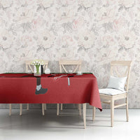 Red tablecloth on a dining table with green trim and sports-themed silhouette print
