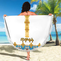 Round white beach blanket with gold cross center, colorful tile border, fringed