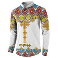 White button sweatshirt with diamond pattern, gold cross front, and long sleeves