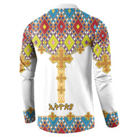 White button sweatshirt with diamond pattern and large gold cross on back