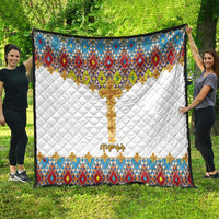 White quilt blanket with multicolor diamond pattern top band, gold cross motif and side border