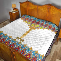 Quilted bedspread with colorful cross and tile border on white background