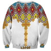 Unisex white sweatshirt back with colorful geometric cross pattern and gold cross graphic