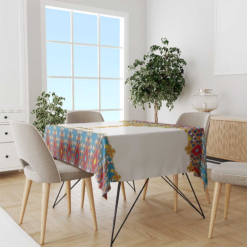 Tablecloth on dining table: geometric blue red yellow border with gold cross details