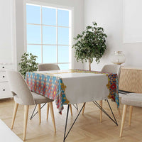 Tablecloth on dining table: geometric blue red yellow border with gold cross details
