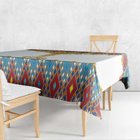 Tablecloth with blue-red geometric panel and gold cross trim draped over chair