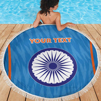 Blue round beach blanket with white fringe and India-style wheel emblem, your text on center