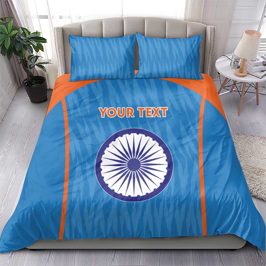 Blue duvet cover set with orange accents, circular India emblem, and two matching pillows