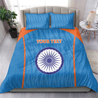 Blue duvet cover set with orange accents, circular India emblem, and two matching pillows