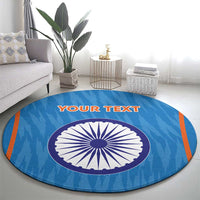 Blue round cricket rug with central India-style wheel graphic and orange border stripes