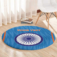 Blue round cricket rug with central India-style wheel graphic on light wood flooring