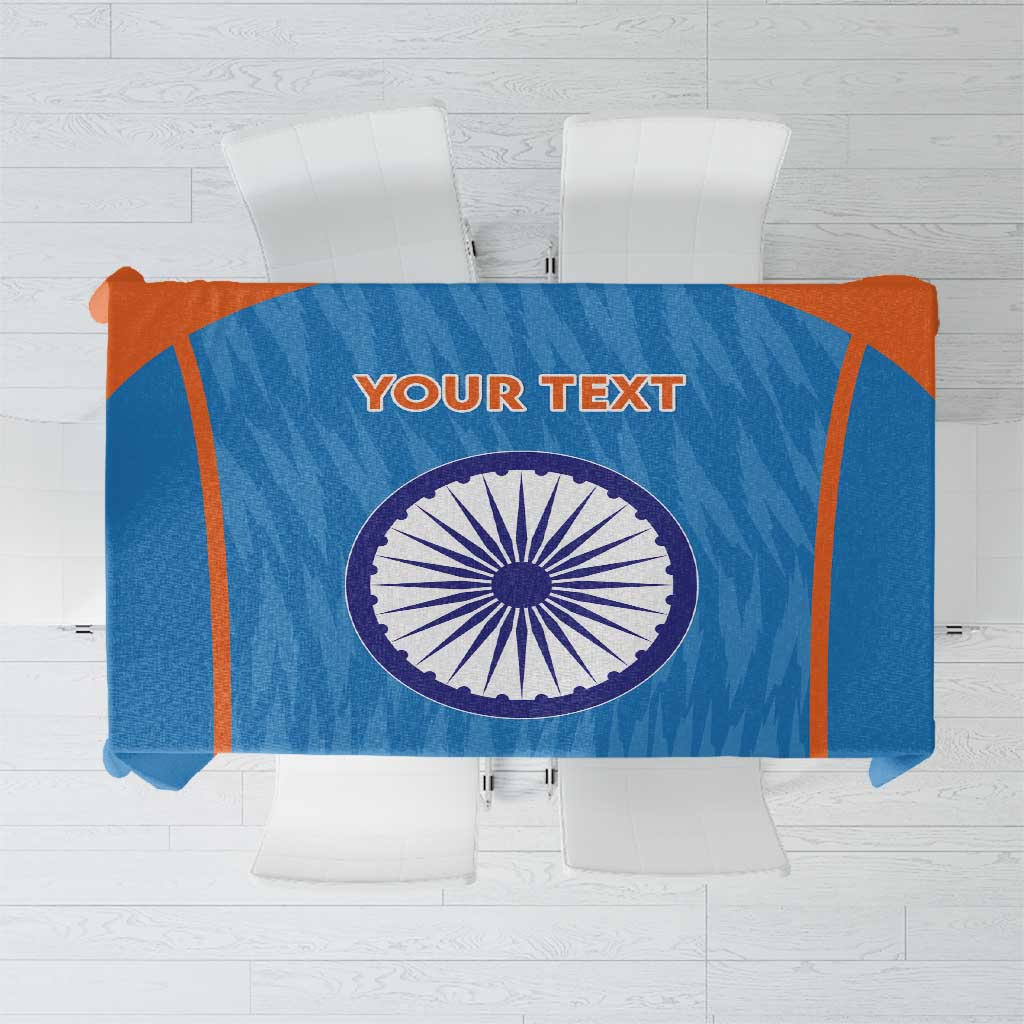 Blue cricket tablecloth with orange trim and circular India emblem, text area centered