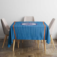 Blue cricket tablecloth with orange trim and India emblem, neatly over table