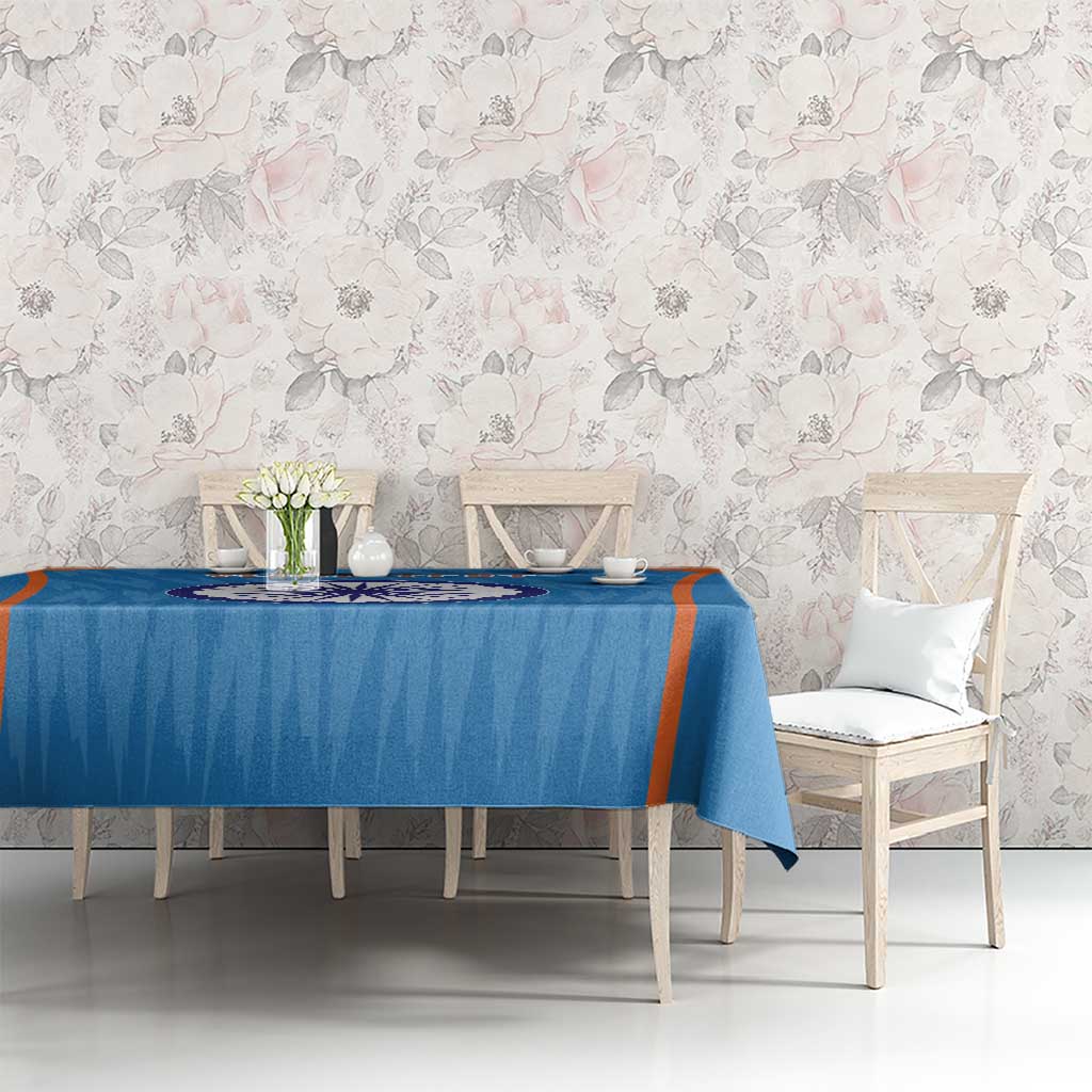 Blue tablecloth with orange border stripe and India emblem at center