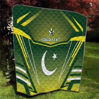 Green quilt laid on grass with yellow-and-white Pakistan flag graphic and "YOUR TEXT"