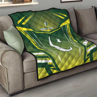 Green quilt on sofa with yellow-and-white Pakistan flag graphic, crescent and star, "YOUR TEXT"
