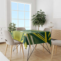 Green custom cricket tablecloth with geometric stripe pattern draped over dining table