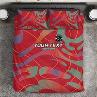 Red custom football bedding set with camo print and pillows, logo badge at center.