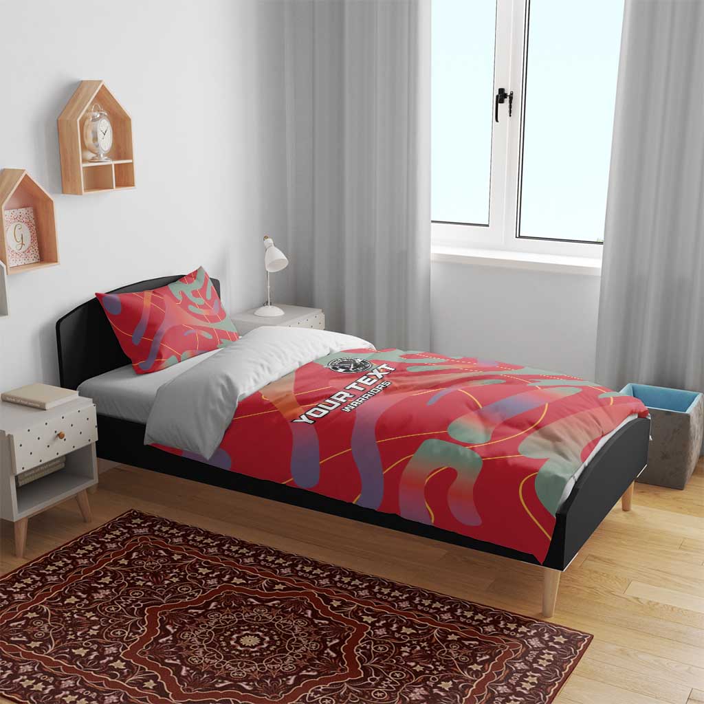 Red custom football bedding set on bed with camo print, pillowcases, central logo badge.