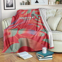 Red and teal football blanket draped with YOUR TEXT WARRIORS print and emblem