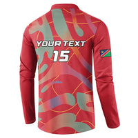 Back of red long-sleeve button polo with YOUR TEXT 15 and abstract camo print