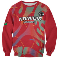 Red crewneck football sweatshirt with Namibia Warriors logo and camo graphic, long sleeves